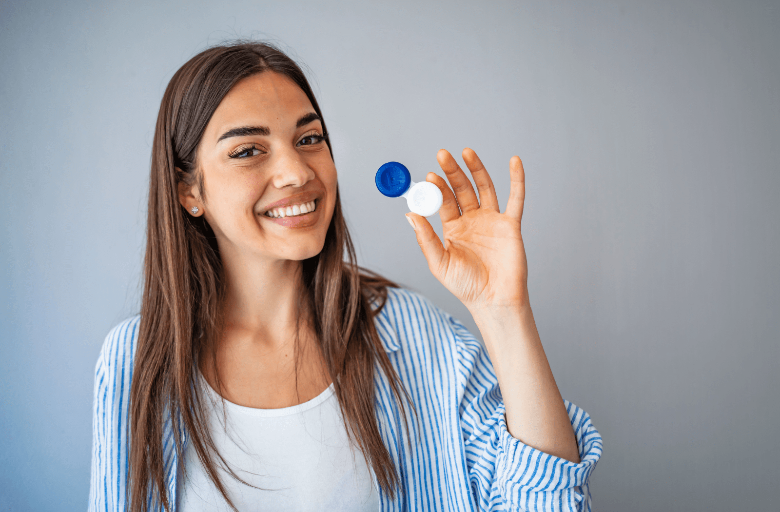 A woman holding a contact lens case